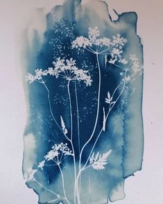 a blue and white watercolor painting of flowers on a piece of paper that has been altered to look like ink