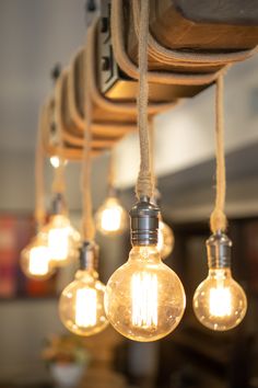 several light bulbs are hanging from the ceiling