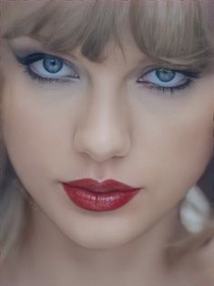 a woman with blue eyes and red lipstick