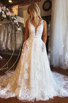 a woman in a wedding dress looking down at the floor