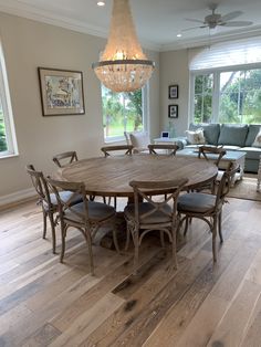 a dining room table with six chairs and a chandelier