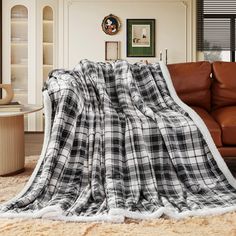 a black and white plaid blanket sitting on top of a couch