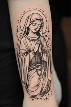 Tattoo of a praying woman with a halo and rosary beads on an arm. Mary Forearm Tattoo, Mother Mary Tattoo Design, Virgin Mary Tattoo For Women, Virgin Mary Tattoo Design, Mary Tattoo Design, Virgin Mary Tattoos, Hands With Rosary, Mary Tattoos, Mother Mary Tattoos