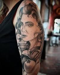 a woman's arm with tattoos on it