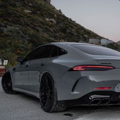 the rear end of a grey sports car