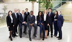 a group of business people posing for a photo