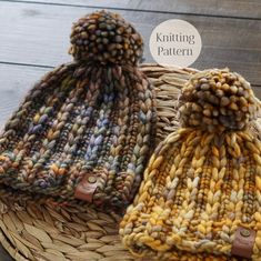 two knitted beanies sitting on top of a woven basket next to each other