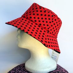 This polka dot reversible girls bucket hat is made using high quality 100% cotton fabric. It is completely handmade by me in Australia. One side has a red polka dots and the other side is black.  These are the sizes I have available. Please click on the options to see what I have left. size 3 to 6 months - aprox 45cm size 6 to 12 months - aprox 47cm size 1 to 3 years - aprox 49cm size 3 to 6 years - aprox 52cm * this is a guide only as all kids are different Since photographing this hat, I have Fun Red Bucket Hat, Red Polka Dot Hat, Mod Earrings, Kids Bucket Hat, Kids Sun Hat, Laser Cut Earrings Acrylics, Head Wrap Scarf, Crochet Bucket Hat, Cotton Hat