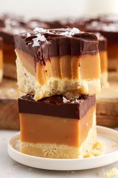 three pieces of dessert sitting on top of a white plate