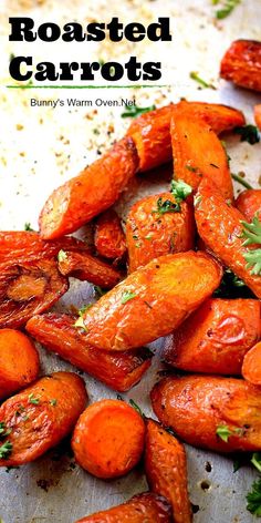 roasted carrots on a baking sheet with parsley sprinkled on top and the words roasted carrots written above them