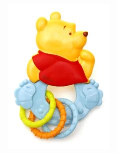 a winnie the pooh teethpick with a toy on it's back