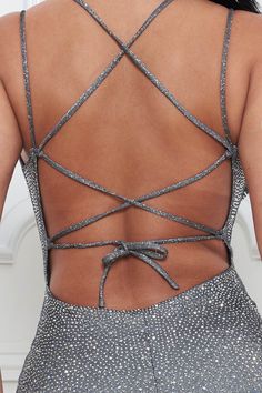 the back of a woman's dress with an intricate cut out design on it