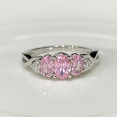 Vintage Sterling Silver Oval Pink Sapphire & White Topaz Three Stone Ring ....Marked 925...Total of weights 2.2grams...Size 7...Measure of Face 7.2MM...It's in very good condition. Oval Three Stone Sterling Silver Jewelry, Pink Oval Three Stone Jewelry, Pink Oval Three-stone Jewelry, Oval Birthstone Ring With Center Stone, Oval Birthstone Ring, Oval Three Stone Cubic Zirconia Jewelry, Oval Three Stone Cubic Zirconia Ring, Three Stone Topaz Ring In Sterling Silver, Oval Topaz Ring With Cubic Zirconia For Anniversary