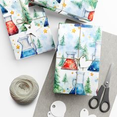 some wrapping paper and scissors are sitting on a table next to yarn, scissors and other crafting supplies