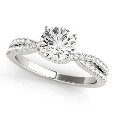 a white gold ring with diamonds on the band and a center stone in the middle