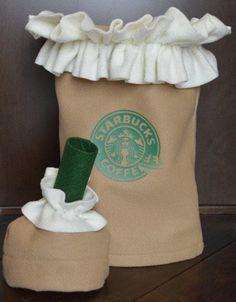 a starbucks bag with a green coffee cup in it