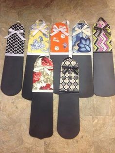 five snowboards are lined up on the floor and one is decorated with different designs