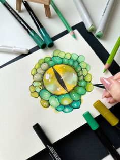 someone is drawing something with colored pencils