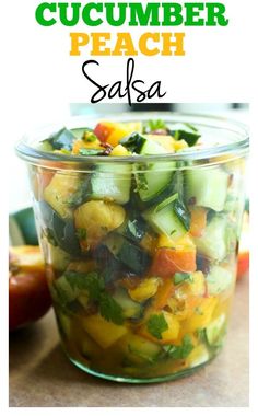 a glass bowl filled with cucumber peach salsa