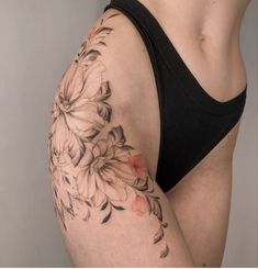 a woman's lower half with flowers on her arm and the bottom half of her body