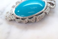 Metal: 14kt White Gold Stone: Diamond And Turquoise Shape: Round And Oval Turquoise Weight: 62 ctw, 39.53 x 29.83 mm Diamond Weight: 1.14 ctw Weight of entire piece with chain: 32.30 grams Length Of Pendant From Top To Bottom: 65.60 mm Width Of Pendant: 45.56mm Type of Chain: 1.60mm Wheat Chain. Length Of Chain: 16 Inches Type Of Closer: Lobster Clasp Customization: We can make this piece in any color gold or gem combination. Note: We have 100s of chains to choose from instead, or we can sell th Elegant Blue Turquoise Cabochon Necklace, Elegant Blue Cabochon Turquoise Necklace, Elegant Blue Turquoise Necklace With Cabochon, Elegant Turquoise Cabochon Pendant Necklace, Elegant Oval Turquoise Necklace, Luxury Turquoise Cabochon Necklace, Elegant Turquoise Cabochon Necklace, Elegant Blue Oval Turquoise Necklace, Elegant Oval Blue Turquoise Necklace