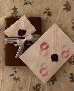 two envelopes are decorated with lace and red lipstick on them, one is for someone's 30th birthday