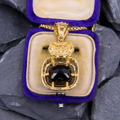 This lovely enhancer pendant is crafted of 14k yellow gold and features a checkerboard cut black onyx and diamond accents. We have added an 18 inch long 14k yellow gold rounded box chain weighing approximately 3 grams. Gold Onyx Pendant Jewelry, Elegant Onyx Jewelry With Large Pendant, Hallmarked Square Pendant Jewelry For Formal Occasions, Formal Square Pendant Box Chain Jewelry, Gold Onyx Jewelry For Anniversary, Gold Onyx Jewelry For Anniversaries, Yellow Gold Onyx Pendant Necklace, Gold Onyx Round Pendant Jewelry, Evening Onyx Jewelry In Yellow Gold