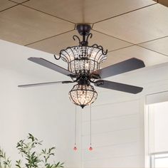 a chandelier hanging from the ceiling in a room with white walls and wood floors