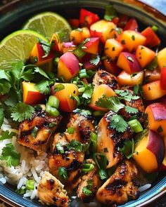 a bowl filled with chicken, mangoes and rice