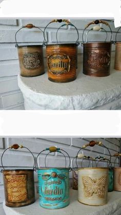 four different tin canisters sitting on top of a white shelf