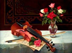 a violin sitting on top of a table next to a vase filled with flowers