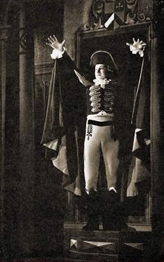 an old black and white photo of a man in costume