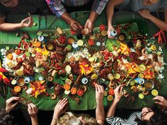 several people sitting around a table with food on it