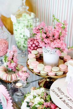 a table topped with lots of cakes and cupcakes