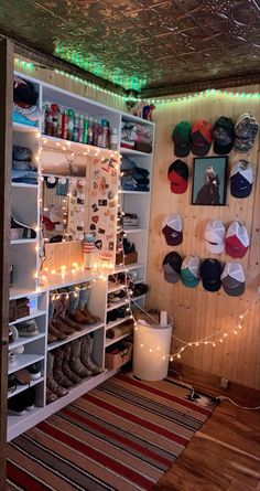 a room filled with lots of shoes and lights on the wall next to a rug