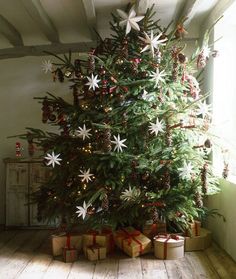 a christmas tree with presents under it