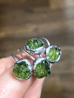 Handcrafted ring combines 925 sterling band with clear AAA+ quality green Peridot. Called “the extreme gem” by the Gemological Institute of America, Peridot is born of fire and brought to light, one of only two gems (Diamond is the other) formed not in the Earth’s crust, but in molten rock of the upper mantle and brought to the surface by the tremendous forces of earthquakes and volcanoes. Peridot has also been found (in its basic form called olivine) in meteorites, on Mars and the moon. Associa Unique Peridot Jewelry For May Birthstone, Peridot Gemstone Ring Gift, Lime Green Peridot Promise Ring, Peridot Ring Gemstone Gift, Lime Green Gemstone Ring Jewelry, Lime Green Gemstone Ring, Peridot Birthstone Ring Jewelry, Handmade Peridot Rings As Gift, Handmade Peridot Rings For Gift