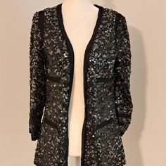 Rachel Zoe Sequined Black And Gun Metal Grey Cardigan Jacket Nwt Size Large. Beautiful Jacket With Trim Pockets. Black Chain Accent Around Jacket Opening And Collar. Lined Jacket. Shell 95% Nylon/5% Polyester. Lining 100% Nylon. Measurements; Shoulder - Shoulder Laid Flat - 16" , Pit To Pit - 19" , Sleeve Length - 18.5", Jacket Length From Shoulder To Hem - 27" . Sequin Winter Cardigan For Night Out, Chic Sequined Cardigan For Fall, Fitted Cardigan For Fall Party, Fall Sequin Cardigan For Night Out, Sequin Cardigan For Night Out In Fall, Open Front Cardigan For Fall Parties, Chic Long Sleeve Sequined Cardigan, Open Front Cardigan For Party In Fall, Fitted Chic Sequined Cardigan