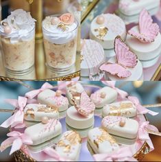 there are many cookies on the table with pink flowers and butterflies around them, along with other desserts