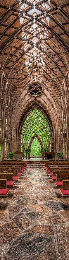 the inside of a church with rows of pews and red seats on each side