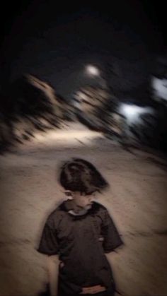 a blurry photo of a young boy walking in the snow