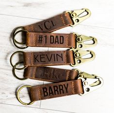 three leather keychains with the words, vcl 1 dad kevin and luke barry printed on them