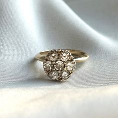 a close up of a ring on a white cloth