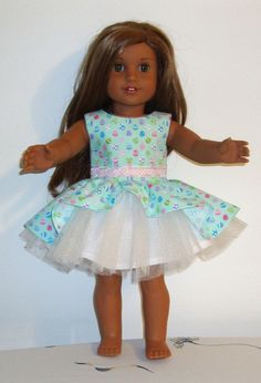 the doll is wearing a dress with polka dots on it