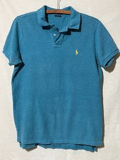 Vintage 1980s polo Ralph Lauren polo shirt. Size medium. Made in Sri Lanka. Custom fit. 100% cotton. Light Blue Summer Polo Shirt, Light Blue Fitted Polo Shirt With Polo Collar, Fitted Light Blue Polo Shirt With Polo Collar, Fitted Light Blue Polo Shirt, Fitted Light Blue Short Sleeve Polo Shirt, Vintage Blue Collared T-shirt, Vintage Cotton Polo Shirt, Vintage Blue Short Sleeve Polo Shirt, Vintage Green Short Sleeve Polo Shirt