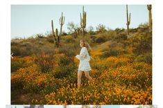 a woman in a white dress walking through a field of yellow flowers and cacti