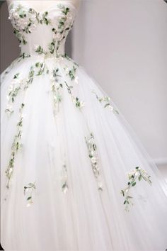 a white dress with green flowers on it