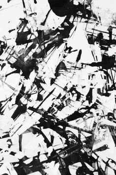 an abstract black and white painting with lots of small pieces of paint on the ground