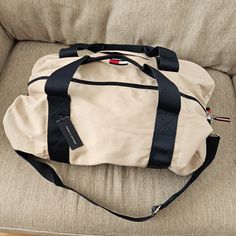 This Duffel Bag Is Brand New, No Issues Or Damage. Measures 20in X 13in X 10in, Can Be Stuffed Bigger That That Of Course. It's A Good Size For A Personal Item For Traveling Feel Free To Comment With Any Questions Everyday Tommy Hilfiger Bag With Zipper Closure, Cream Rectangular Bag For Weekend Trips, Tommy Hilfiger Travel Bags With Zipper Closure, Rectangular Cream Bag For Weekend Trips, Tommy Hilfiger Rectangular Travel Shoulder Bag, Tommy Hilfiger Rectangular Shoulder Bag For Travel, Beige Tote Shoulder Bag For Overnight Trips, Tommy Hilfiger Shoulder Bag For Travel, Tommy Hilfiger Travel Shoulder Bag