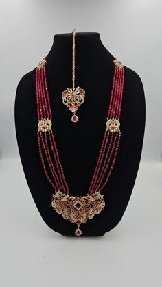 Long necklace Red Temple Jewelry For Eid, Red Kundan Necklace With Intricate Design For Ceremonial Occasions, Ceremonial Red Kundan Necklace With Intricate Design, Red Tikka With Intricate Design For Festive Occasions, Red Chandbali Tikka With Intricate Design, Red Bollywood Tikka As Gift, Traditional Long Beaded Necklaces For Wedding, Red Jewelry With Stone Work For Eid, Bollywood Style Necklaces For Eid Ceremonial